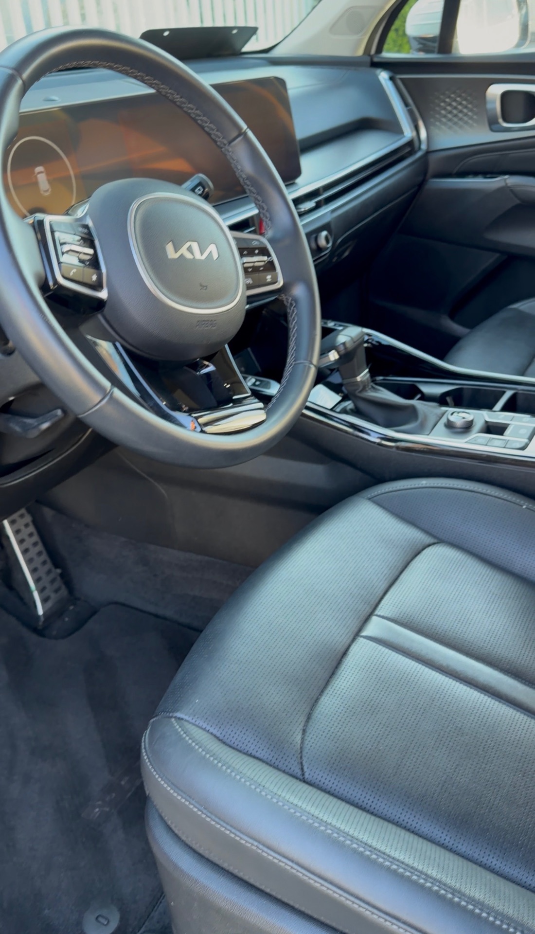 Kia interior detail — spotless dash, seats and console